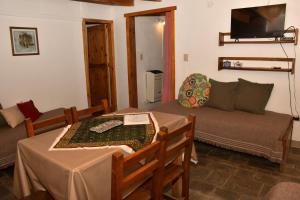 a living room with a couch and a table at Girgola hospedaje in Villa Pehuenia