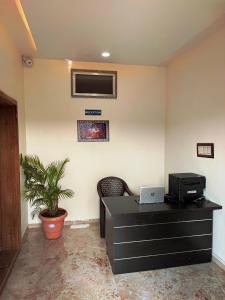 an office with a desk with a computer on a wall at RT RESIDENCY HOTEL and LODGE in Nandurbār +17 photos