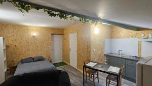 una camera con letto e tavolo e una cucina di studio 4 a Fains-les-Sources