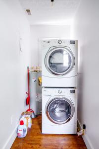 une laveuse et une sécheuse dans une petite pièce dans l'établissement Jungle House Chillicothe - Luxury Downtown Homes Free Parking, à Chillicothe 72 autres photos