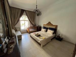 a bedroom with a bed and a window at South Hammamet Pool Villa in Hammamet Sud +24 photos