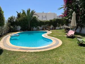 a swimming pool in the yard of a house at South Hammamet Pool Villa in Hammamet Sud
