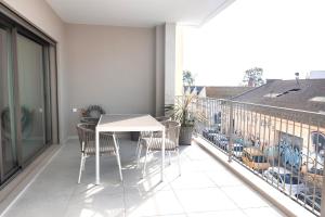 a balcony with a table and chairs on it at Conserveira 8 in Olhão