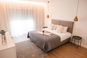 a bedroom with a bed with a stuffed animal on it at Conserveira 8 in Olhão