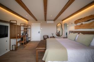 a bedroom with a large bed and a desk at Casa Pradera - Hotel Serrano in Sierra de los Padres