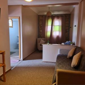 een woonkamer met een bank en een raam bij Ferme d'hôtes Safi in Safi