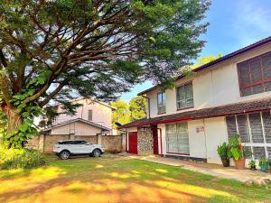a car parked in front of a house at Luxury small Homely Apt villa in Kisumu