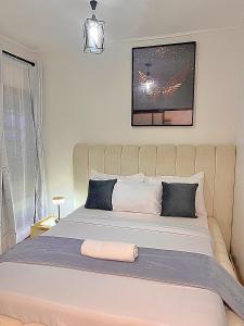 a bedroom with a large bed with a white bedspread at Luxury small Homely Apt villa in Kisumu +22 photos