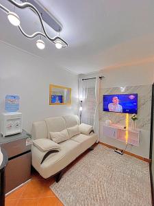 a living room with a couch and a tv at Luxury small Homely Apt villa in Kisumu