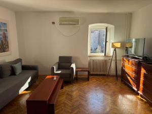 een woonkamer met een bank en een tv bij Apartment Kovacevic Old Town in Budva