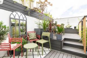 a patio with colorful chairs and plants at Liberties Pre63 Studios in Dublin +7 photos