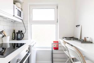 a kitchen with white counters and a window at Liberties Pre63 Studios in Dublin