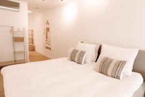 a white bed with white pillows in a bedroom at B&B s12 in Doetinchem