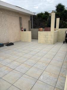 a tile patio in front of a house at Logement catalan in Perpignan