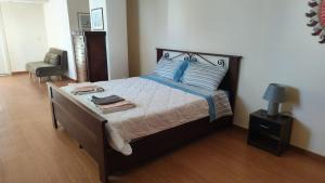a bedroom with a bed with blue pillows and a chair at FONDO VERSACE in Reggio di Calabria