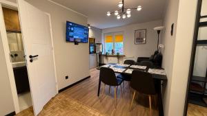 a dining room and living room with a table and chairs at W Centrum in Piła