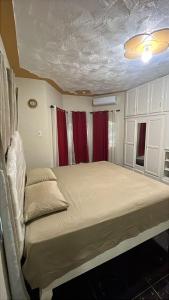 una camera da letto con un grande letto con tende rosse di Doreen's Ranch Master Suite a Four Paths