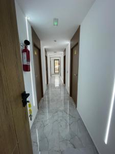 a hallway of a hotel with a tile floor at Hôtel kairouan in Fez +1 photo