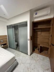 a bedroom with a bed and a sliding glass door at Hôtel kairouan in Fez