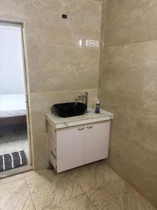 a bathroom with a sink on a counter with a mirror at Rainbow721 Earth in Pondicherry +21 photos