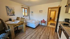 a living room with a table and a couch at Mountain Suite Brixen in Brixen im Thale