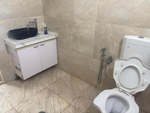 a bathroom with a toilet and a sink at Rainbow721 Earth in Pondicherry