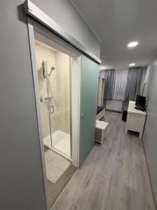 a bathroom with a shower and a glass door at ''Am Limes'' Hotel in Enns +68 photos