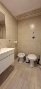 een badkamer met een wastafel, een toilet, een badkuip en een bidet bij El encanto del lago in Bariloche