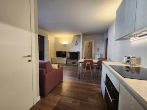 a kitchen and living room with a table and chairs at Valmalenco Home in Chiesa in Valmalenco