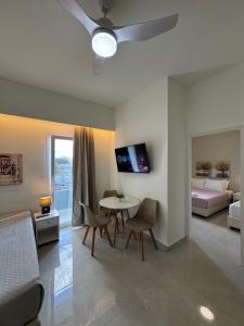 ein Wohnzimmer mit einem Bett und einem Tisch und Stühlen in der Unterkunft Eva Ivoni apartments in Ammoudara + 73 Fotos
