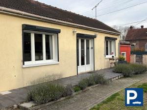 een geel huis met witte ramen en een patio bij Maison de Plain-pied à 15 mins de Compiègne 