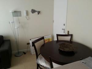a dining room with a black table and chairs at Zapahuira in Arica
