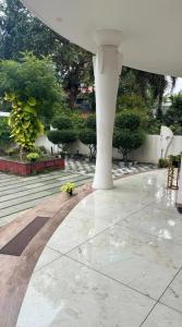 a patio with a white structure with flowers on it at Krishnamadom in Kollam +4 photos