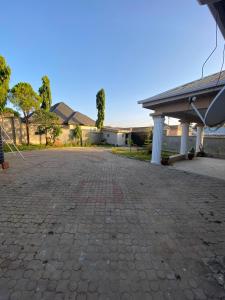 an empty driveway in front of a house at Flamingo 1 spacious solar powered 2 bedroom home with a stocked ready kitchen in Jos