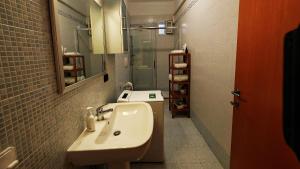 a small bathroom with a sink and a shower at Giro di Bitta in Giovinazzo