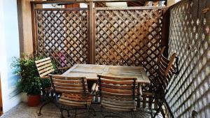 a wooden table and chairs on a patio at Giro di Bitta in Giovinazzo