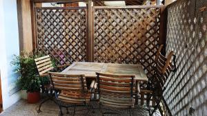 a wooden table and chairs on a patio at Giro di Bitta in Giovinazzo +6 photos