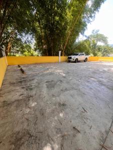 a car parked in a parking lot next to a yellow fence at Acogedor Apartamento en Copán in Copán Ruinas