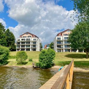 a bridge over a river with buildings in the background at Design-Wohnung am Plöner See in Ascheberg