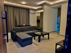 een woonkamer met een bank en een tafel bij Soğular Apartments 1 in Aglantzia +8 foto's