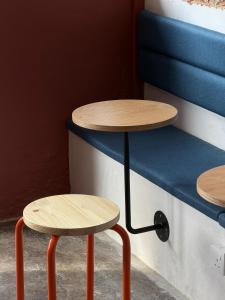 two tables and two stools in a room at Aayu Seckchuan - 3 mins walk to Love Lane in George Town