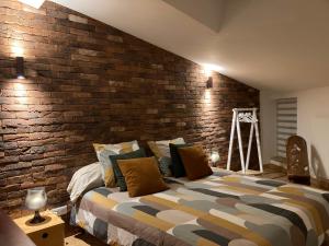 En eller flere senge i et værelse på L'atelier du faubourg