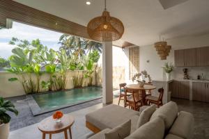 an open kitchen and living room with a swimming pool at Waringin Villa Ubud in Ubud