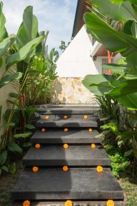 a set of stairs with oranges on them at Waringin Villa Ubud in Ubud