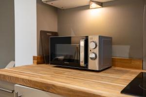 a microwave sitting on top of a counter at Stylish 2 Bedroom APT with Balcony in Leeds