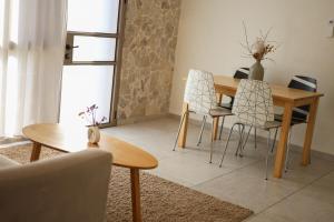 a dining room with a wooden table and chairs at The corner in Sde Ilan in Sede Ilan