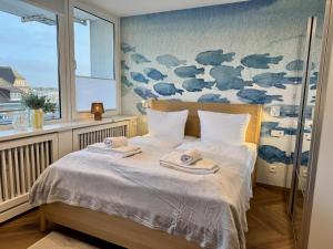 ein Schlafzimmer mit einem Bett, auf dem zwei Handtücher liegen in der Unterkunft Boje in Westerland