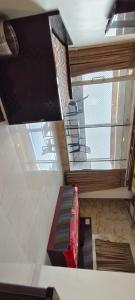 a room with a couch and a large window at Hiral residency in Matheran