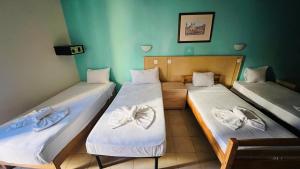 2 letti singoli in una camera con pareti verdi di Quad Room 2636 a San Pawl il-Baħar