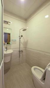 a bathroom with a tub and a toilet and a sink at Dopamine Hotel in Vung Tau